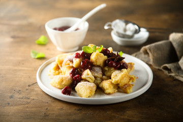 Traditional Austrian pancake dessert with cherry sauce