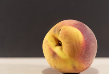 Peach fruits (Prunus persica) in natura on a woody background