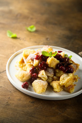 Traditional Austrian pancake dessert with cherry sauce