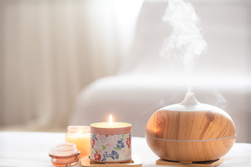 Modern oil aroma diffuser in the living room on the table .