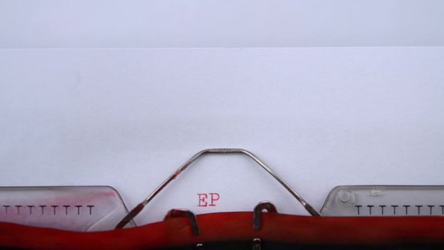Episode 3- phrase printed on an old typewriter in red letters, close up. vintage inscription