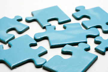 Blue puzzle pieces on white background.