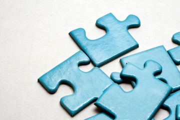 Blue puzzle pieces on white background.