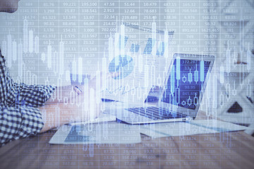 Multi exposure of financial graph with man works in office on background. Concept of analysis.
