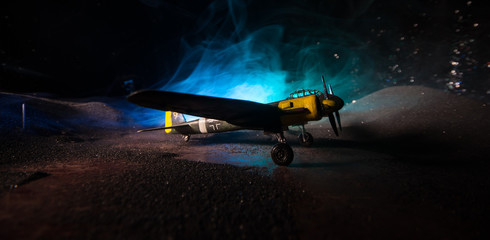 German Junker (Ju-88) night bomber at night. Artwork decoration with scale model of jet-propelled plane in possession.