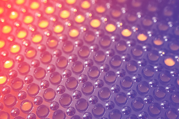 incandescent bulb in front of a led panel