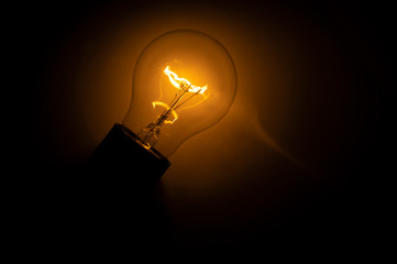 incandescent light bulb on black background
