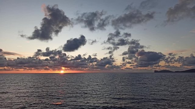 Dark clouds over the sea at sunset. Sardinia, Italy
