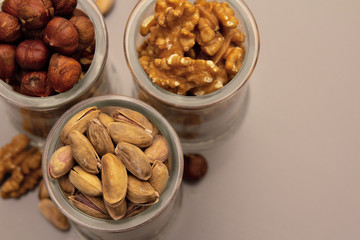 hazelnut, walnut and pistachio nut. mixed assorted nuts in glass box on light background.
