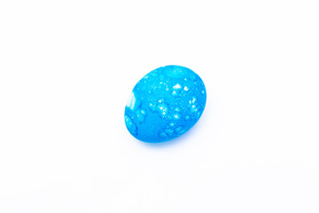 Easter colored egg of turquoise or blue color on a white background.