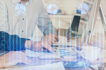 Multi exposure of chart with man typing on computer in office on background. Concept of hard work.