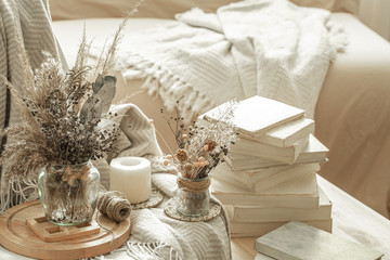 Home interior with books and dried flowers.
