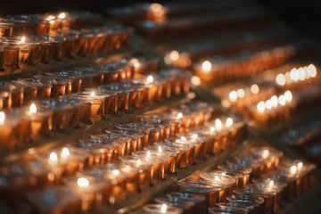 Fototapeta na wymiar Burning candles in a church.