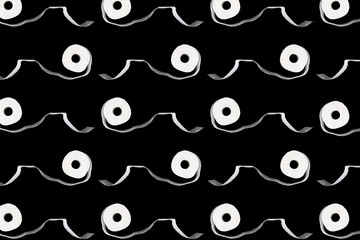 Creative pattern made from white toilet paper rolls on black background. Top view, copy space. Hygiene concept.