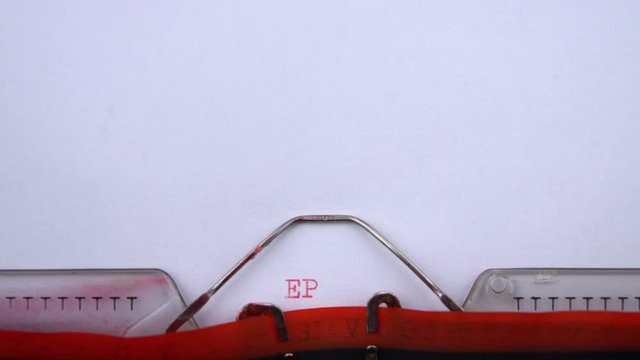 Epidemy - word printed on an old typewriter in red letters, close up. vintage inscription