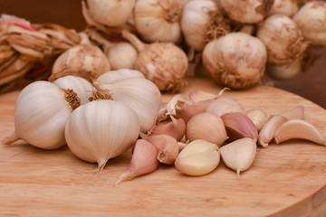 Garlic Cloves and Bulb on wooden cutting board. Garlic on wooden table background