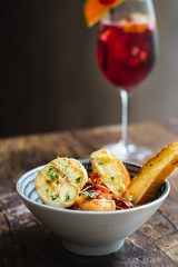 Prawns Al Ajillo with garlic, fried garlic, chilli oil and garlic bread in a bowl