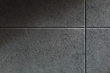 Close up texture of a wall with a grey sound absorbing panel mounted on it. Soundproof wall made of...
