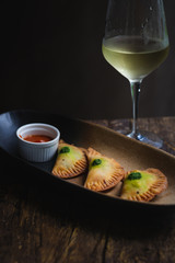 Chicken Empanadas La abuela style pastry puffs, spinach, green chimichurri sauce