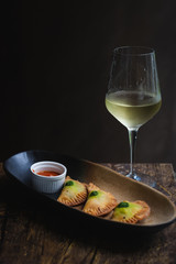 Chicken Empanadas La abuela style pastry puffs, spinach, green chimichurri sauce