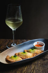 Chicken Empanadas La abuela style pastry puffs, spinach, green chimichurri sauce