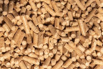 Wooden pellets background, pattern. Close up natural wood pellet. Ecological heating, renewable energy Biofuels. Top view. Flat lay ecological fuel for solid fuel boilers.