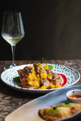 Mojito Chicken Braised boneless chicken thigh, tangy rum reduction, mango salsa, herbed tomatoes & roasted potatoes