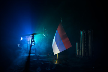 Business dialogue, oil agreement concept: National flags with Oil pump and oil refining factory at...