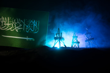 Business dialogue, oil agreement concept: National flags with Oil pump and oil refining factory at...