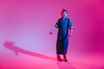 Young stylish girl dancing in the Studio on a colored neon background. Music dj poster design.