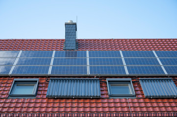 Solar system on the roof of a detached house new with a blue sky