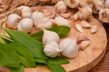 Garlic Cloves and Bulb on wooden cutting board. Garlic on wooden table background