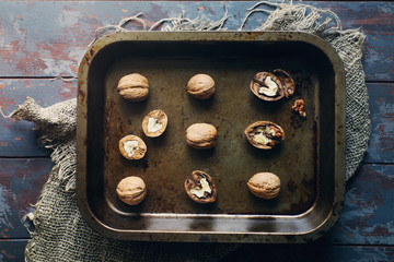 Walnuts in vintage tray on dark wooden table