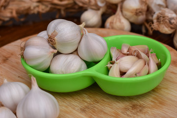 Garlic Cloves and Bulb on wooden cutting board. Garlic on wooden table background