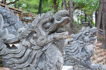 Chinese stone dragons in the Tomb of Tu Duc complex. Hue, Vietnam