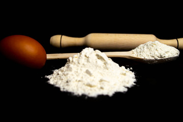 Flour, rolling pin, wooden spoon