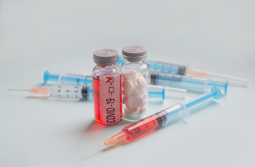 test with coronovirus c in epidemic with.test tube and syringe with blood test and pills in the lab