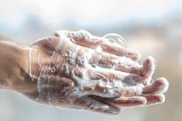 A man washes his hands with soap. Man's hands in foam with bubbles
