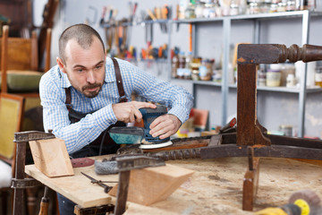 Craftsman using carpentry tools for restoration