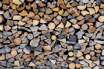 Background of chopped logs stacked in piles