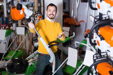 Guy demonstrates convenient mower