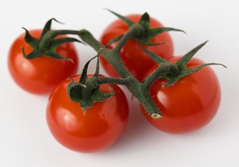 Cherry tomatoes on a light background close-up