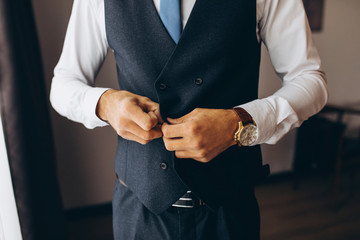 man fastens his jacket closeup
