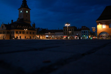 Fototapeta na wymiar Brasov's old city town square in the night, empty because of the coronavirus outbreak.