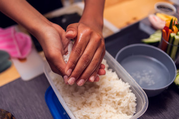 Children making sushi at the master class. Children, education and entertainment.