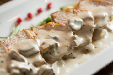 Chicken meat on grated gnocchi in cream sauce of mushrooms and smoked cheese