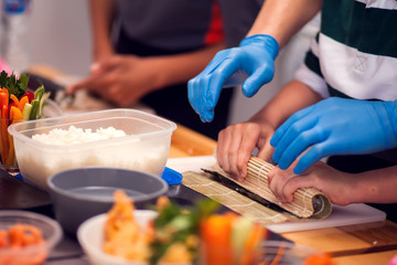Children making sushi at the master class. Children, education and entertainment.