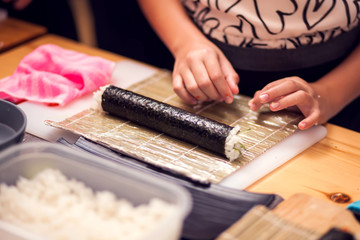 Children making sushi at the master class. Children, education and entertainment.