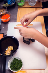 Children making sushi at the master class. Children, education and entertainment.