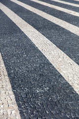 Fototapeta premium Closeup surface of blocky pattern old stone pavement